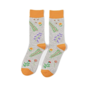 Close-up of grey mid-calf socks featuring orange accents and floral embroidery details