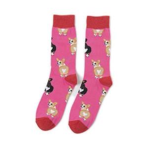 Detail of pink cotton mid-calf socks with cute Corgi dog patterns on plain white background