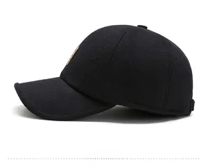 Side view of winter wool baseball cap for men featuring a metallic logo and warm texture
