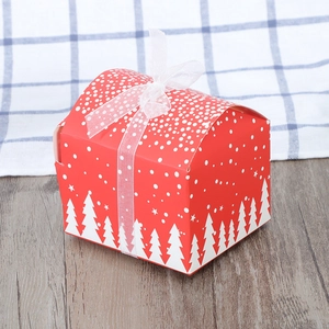 Red Christmas gift box with white snowflake patterns and a sheer mesh ribbon bow
