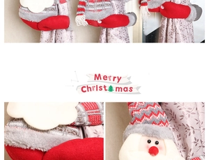 Detail of Christmas Santa curtain buckle with red knitted hat and plush beard textures