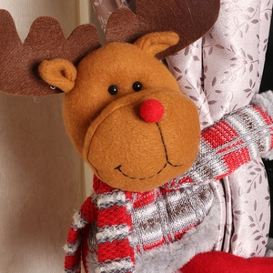 Christmas reindeer curtain tieback with red striped scarf on fabric drapery
