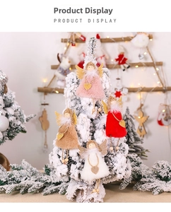 Detail of plush angel ornaments with golden wings and wooden beads on a snowy Christmas tree