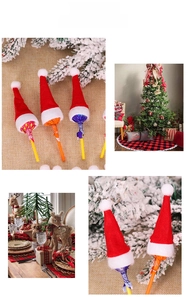 Mini red and white Christmas hats used as festive lollipop decorations for party gifts