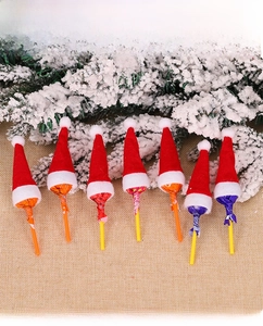 Detail view of 7 mini Santa hats used as decorative toppers for Christmas lollipops
