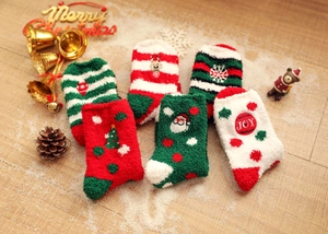 Detailed view of 6-pair Christmas coral fleece socks with reindeer and santa embroidery