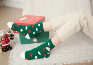 Close-up of thick coral fleece Christmas socks with Santa Claus embroidery on the side