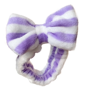 Soft purple striped microfiber headband with a large bow for face washing and makeup