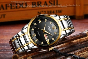 Detail view of steel watch with gold accents, Roman numerals and dual calendar display