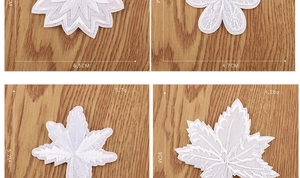 Detailed view of four white rose lace patches with dimensions on a wooden background