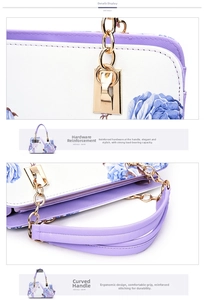 Detail of floral handbag with golden metal chain hardware and purple textured handle