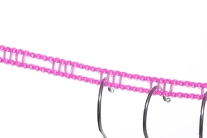Detail of rose pink non-slip clothesline with mesh loops and metal ring attachment