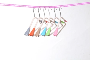Detail of colorful non-slip clothes hangers hanging on a windproof outdoor laundry line
