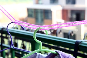 Pink windproof clothesline with anti-slip fence design for outdoor travel laundry use