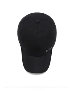 Top view of thick black winter baseball cap with textured wool fabric and metal detail