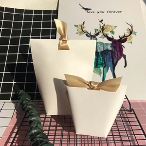 Elegant white pillow gift boxes in two sizes with decorative gold satin ribbon bows