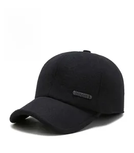 Detail of black wool baseball cap featuring a metal Sport badge and thick lining