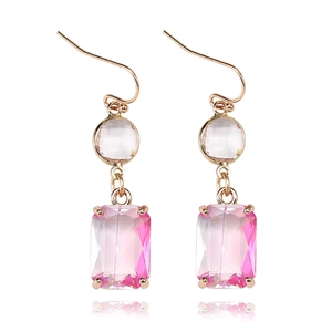 Close-up of pink gradient K9 crystal drop earrings with golden hooks on white background