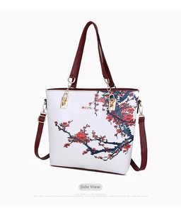 Detailed side view of white tote bag featuring red plum floral print and JINGPIN logo