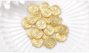 Macro detail of gold metal four-leaf clover pendants for DIY jewelry making