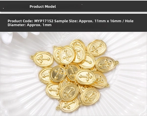 Detailed view of 11x16mm gold oval metal charms with cross relief on a ceramic plate