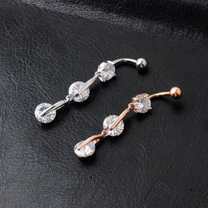 Silver and rose gold belly button rings with three round clear zircons on black leather