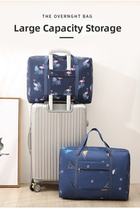 Foldable travel bag detail showing trolley sleeve and flamingo pattern on silver suitcase