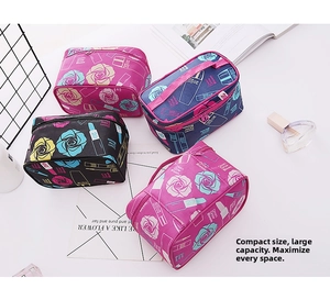 Detail of floral makeup bags with zipper and handle in pink, black, blue and rose red