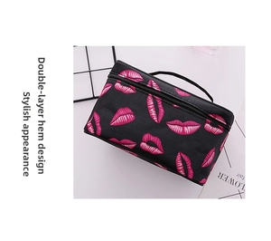 Detail showing double-piping edges on the square black cosmetic bag with pink lip patterns