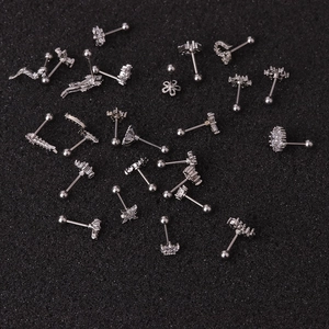 Various silver stainless steel stud earrings with cubic zirconia on black texture background
