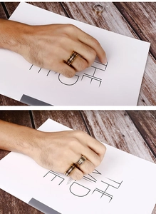 Detail of a men's stainless steel ring with tri-color gold, silver, and black stripes