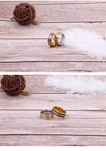 Detailed view of two-tone stainless steel rings in gold and silver on a wooden surface