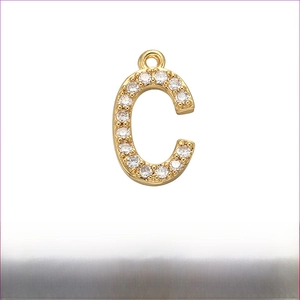 Detailed close-up of golden micro-pave zircon letter C pendant in high-quality brass