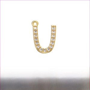 Macro shot of 12mm gold plated brass letter U pendant with micro-pave cubic zirconia