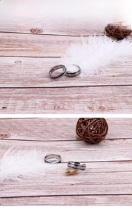 Detail of minimalist stainless steel ring with black inlay on rustic wooden background