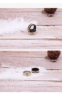 Detail of two-tone stainless steel rings with gear texture on a rustic wooden background