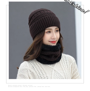Detailed view of dark brown knitted hat and fleece-lined neck warmer winter set