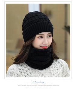 Close-up of black knitted beanie and neck warmer set with soft plush fleece lining details