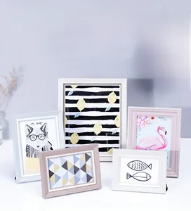 Detailed set of 5 Nordic style photo frames in white pink blue and wood finishes