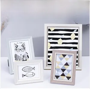 Minimalist Nordic photo frames in wood and white finishes with various art prints