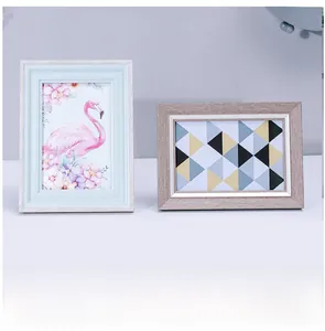 Detail showing two Nordic style wooden photo frames with light blue and natural grain finishes