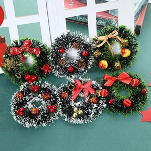 Mini Christmas wreaths set with red bows, bells and pine cones for festive home decoration