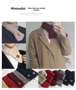 Detail of multi-color ribbed knit scarves showing texture and leather label accents