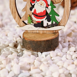 Macro shot of painted wooden Santa Claus ornament on a natural log base with snow effect