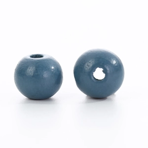Macro shot of Morandi blue wooden beads with smooth finish and central hole for DIY crafts