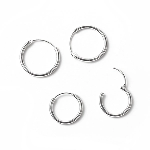 Minimalist silver circular hoop earrings set in four sizes against a white background