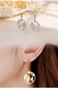 Close-up of world map earrings on model showing size and hollow circular design