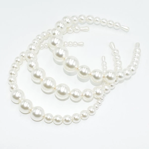 Three-piece set of elegant white pearl headbands with varied bead sizes on metal frames
