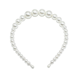Macro shot of large gradient white pearls on a handcrafted wedding headband accessory