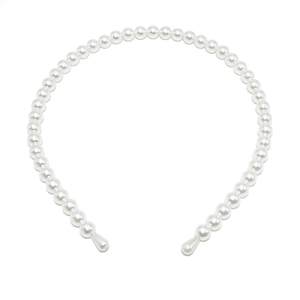 Close-up of handmade white faux pearl headband featuring smooth drop-shaped pearl ends